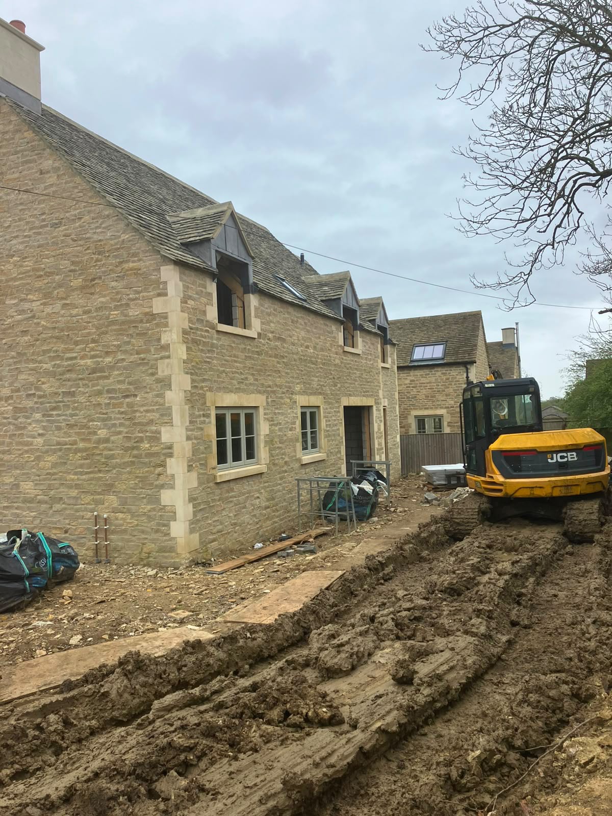 Stone build in progress with excavator on site by DR Smith Building.